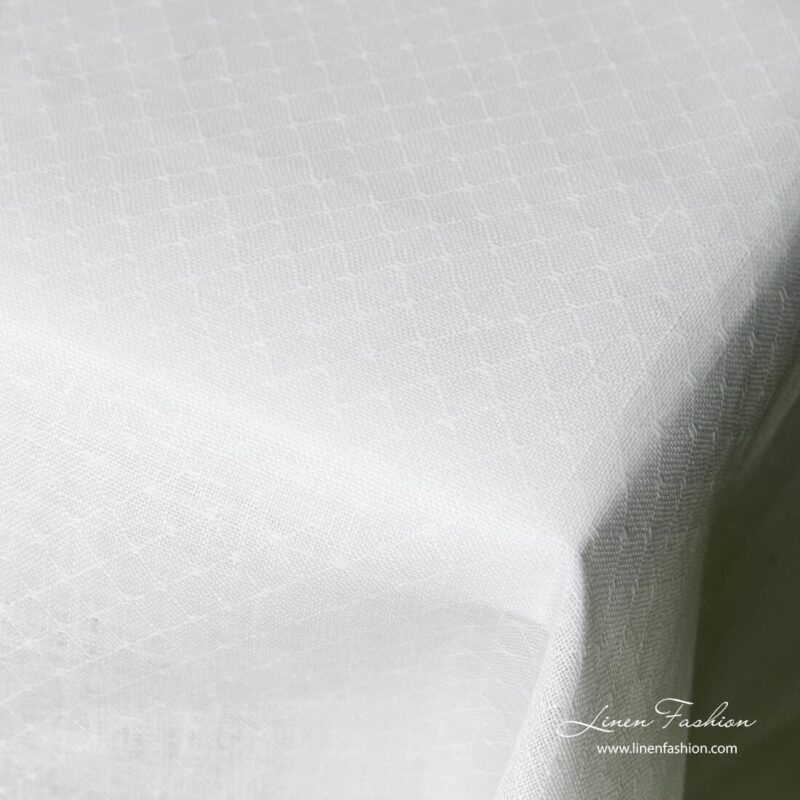 White colored linen tablecloth, white.