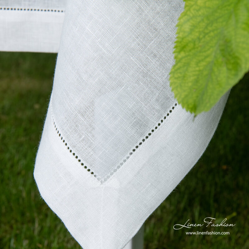 4 cm folded border of hemstitched linen tablecloth