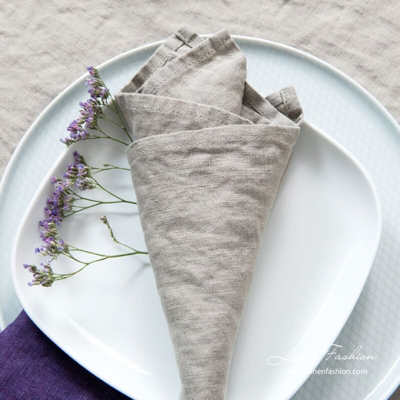 Brownish grey napkin of linen fabric.
