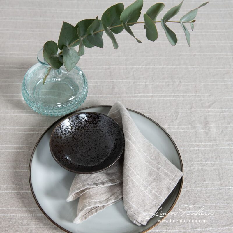 Natural linen color napkin in white narrow stripes, washed fabric