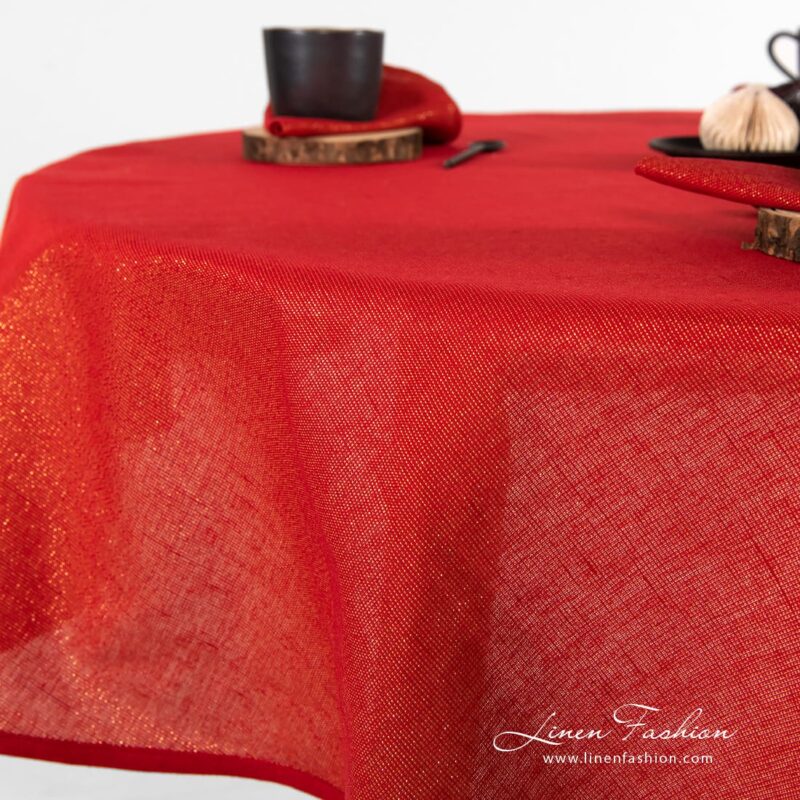 Round red linen tablecloth Donna with gold lurex yarns.