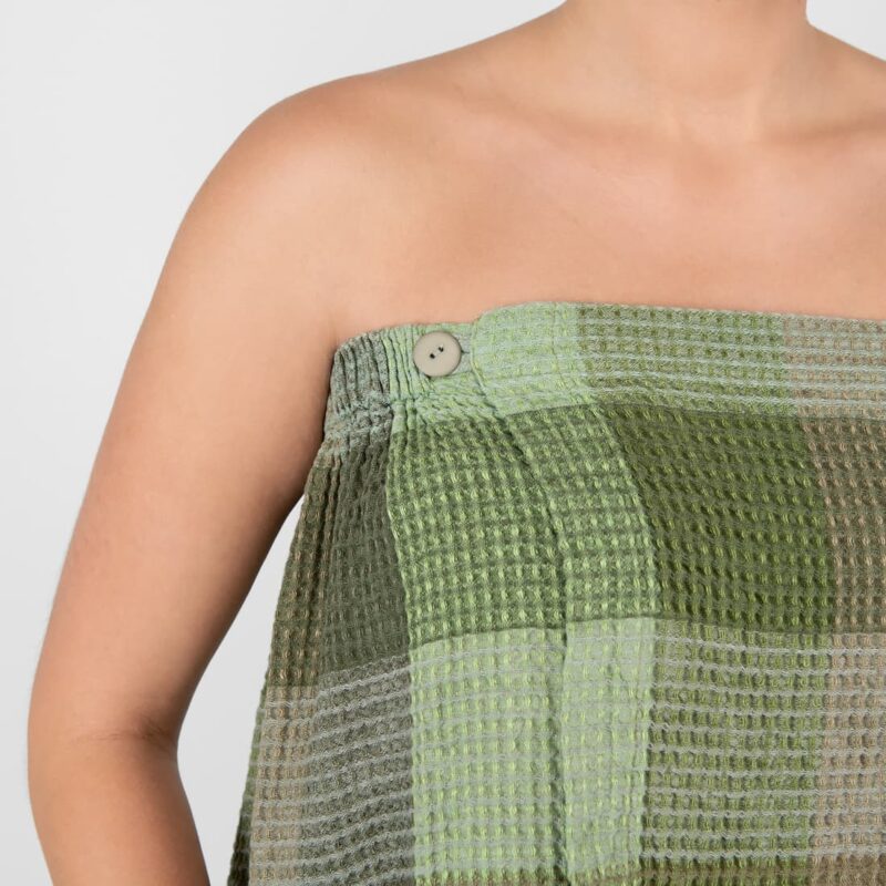 linen green wrap towel with button closure.