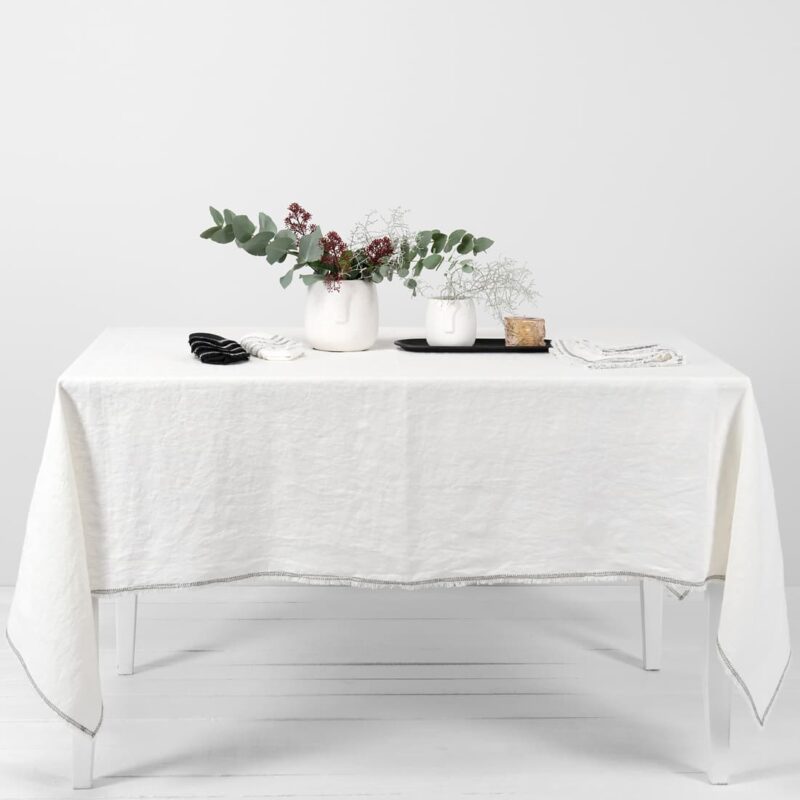white linen tablecloth with decorative seam.