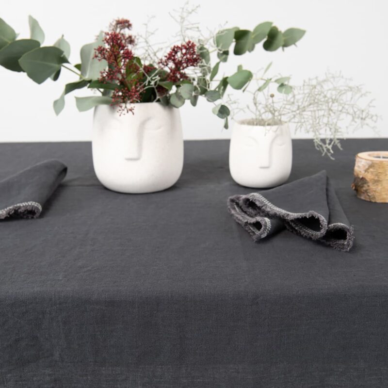 linen grey tablecloth with decorative seam with napkins.
