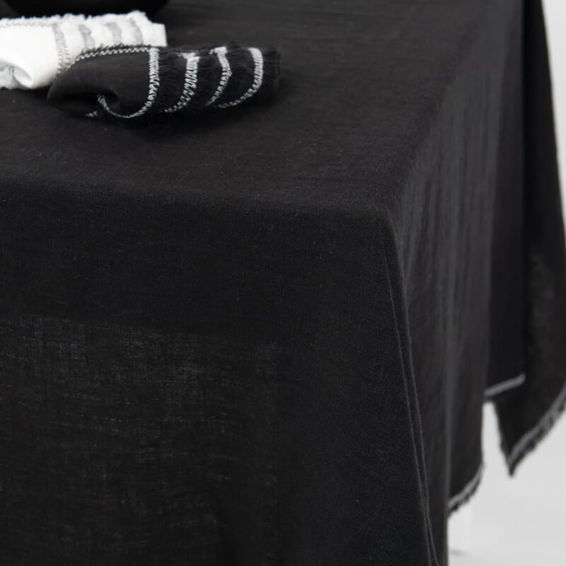 linen black tablecloth with decorative seam, with napkins.