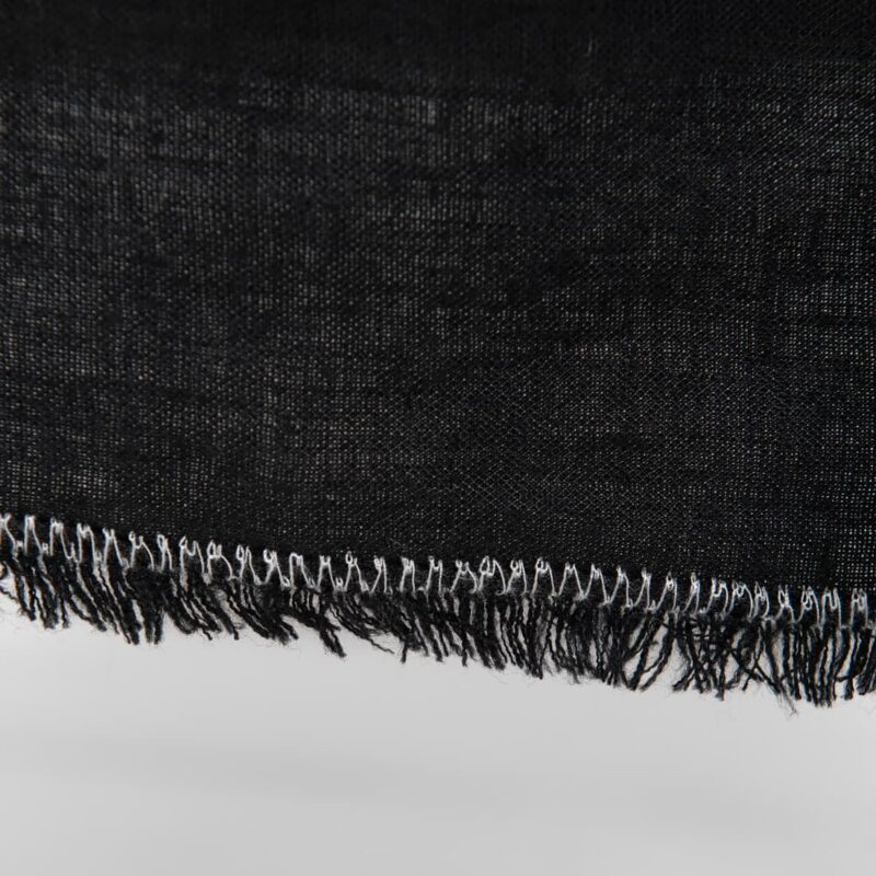 linen black tablecloth with decorative seam & loose fringes.