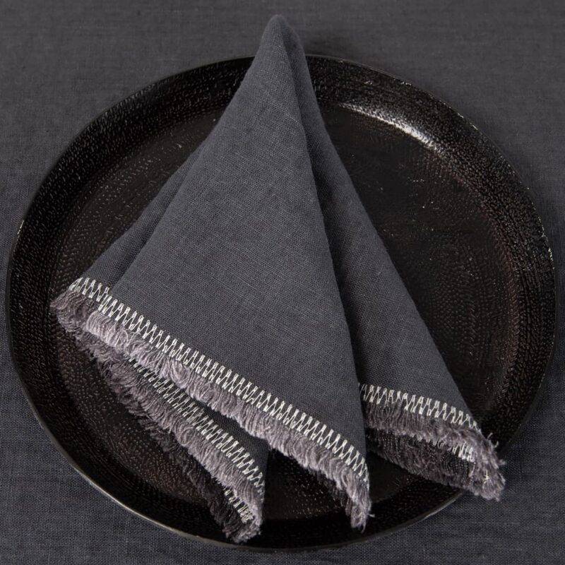 grey linen napkin with decorative stitch.