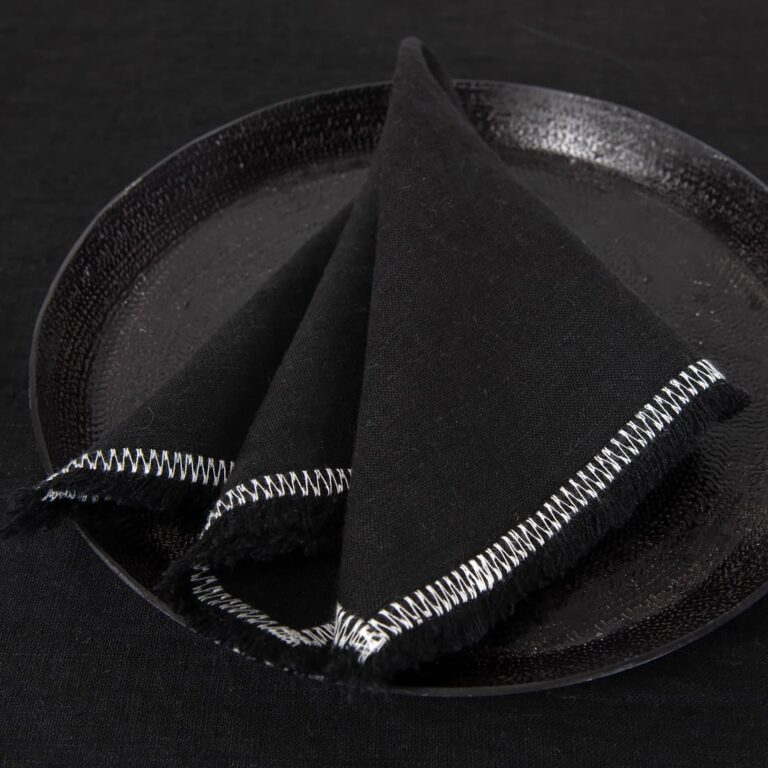 black linen napkin with decorative stitch.