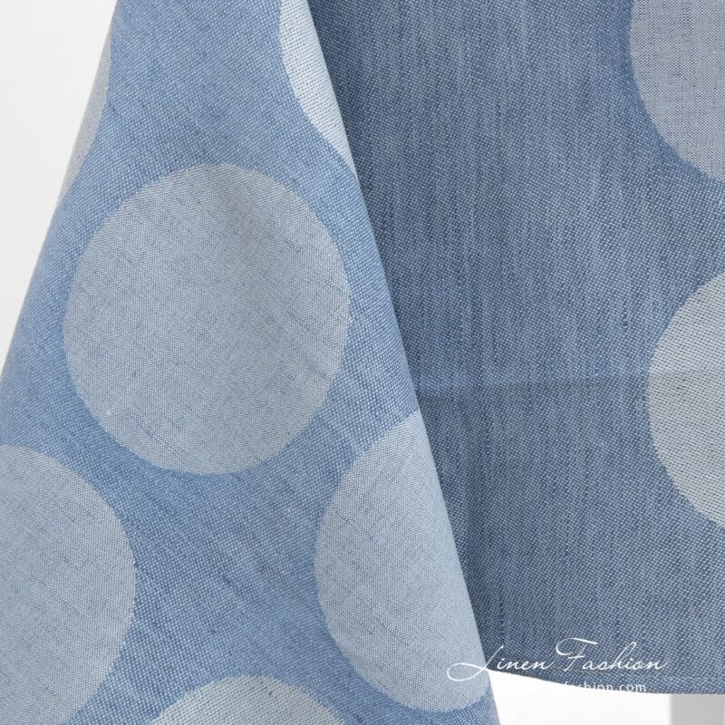 Greyish bubbles on blue tablecloth