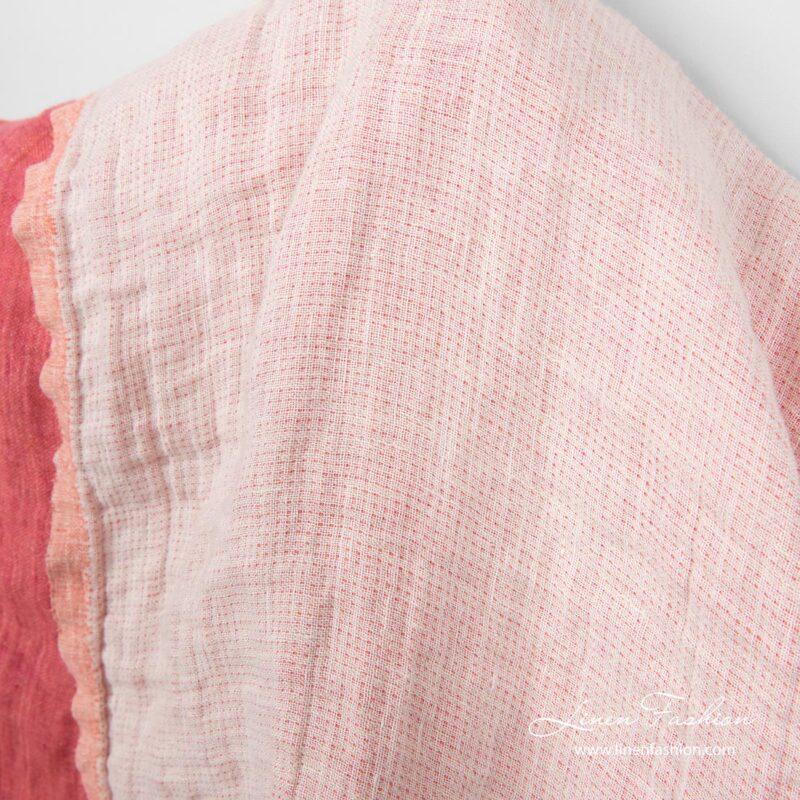 Fabric side woven from white and creamy yarns with rose dots