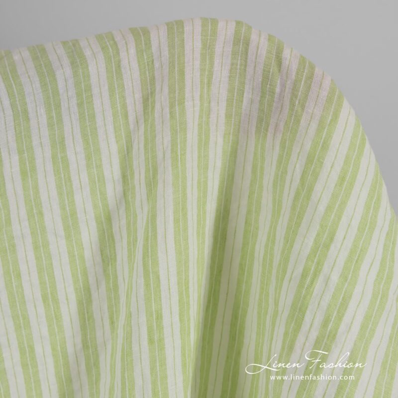 Light green linen fabric in stripes, washed