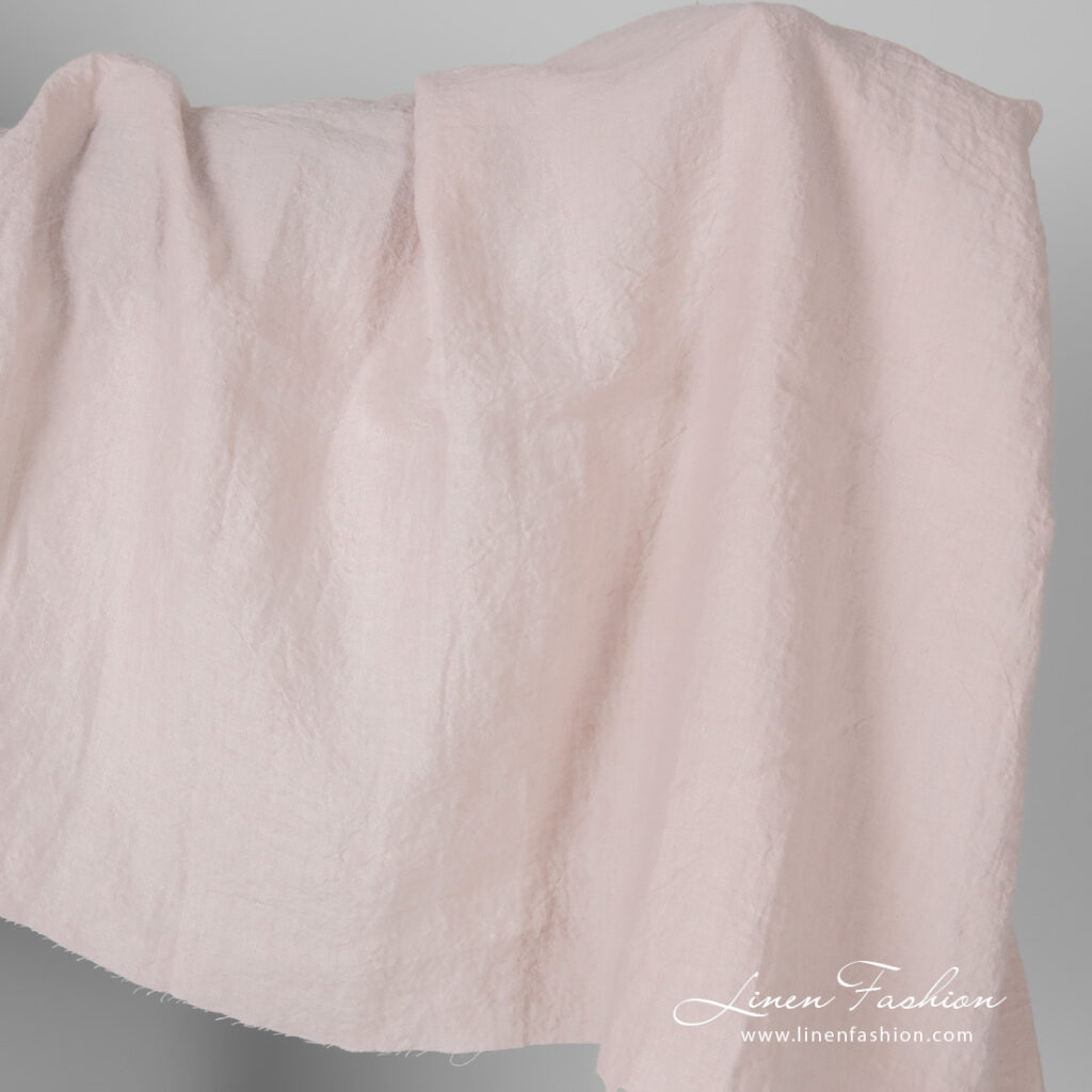 Wide width linen fabric in light pink colour, washed