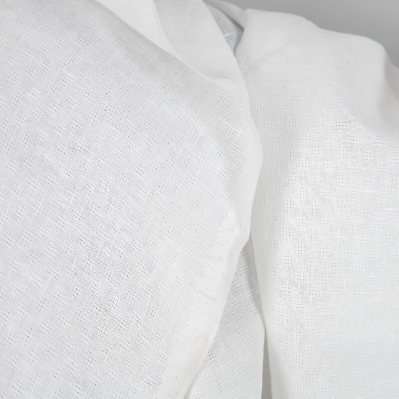 Off-white linen fabric in an openwork pattern texture