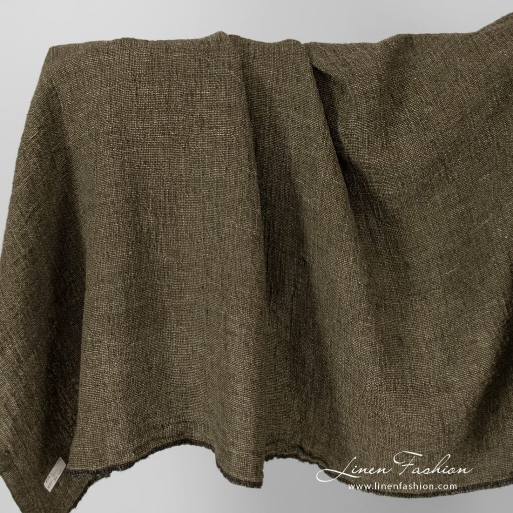 Linen fabric in moss green, washed.