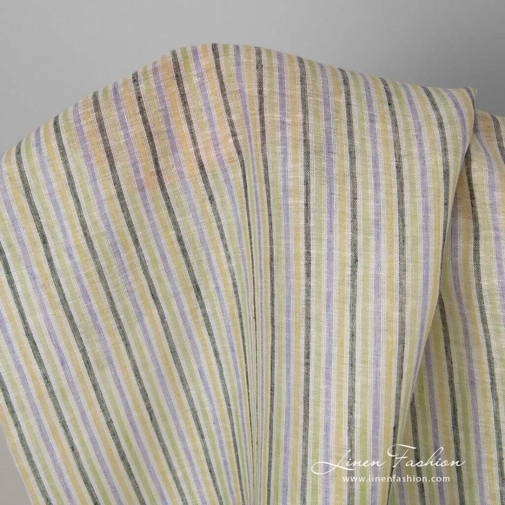 Linen fabric in yellow blue green stripes.
