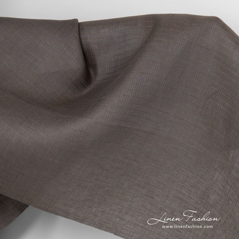 Grey brown linen fabric in herringbone pattern.